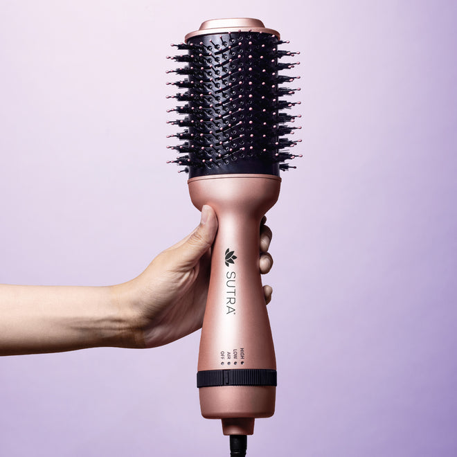 hand-holding-rose-gold-3-inch-professional-blowout-brush