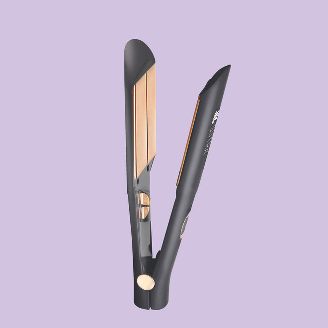 black infrared flat iron, a plate measuring one and a half inches with rose gold color plate, elegant details, on light purple background