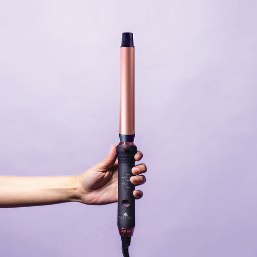 hand-holding-interchangeable-curler-base-with-25mm-clipless-barrel-attached